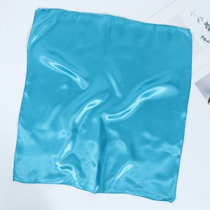 Macro shot of 60cm blue square silk scarf with glossy satin texture and fine edge stitching
