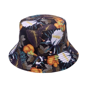 Close-up of double-sided summer bucket hat with vibrant tropical floral pattern details