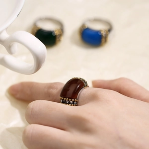 Detailed macro view of a vintage titanium steel ring with brown cat eye stone and gold beads