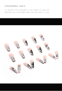 Macro detail of long coffin press-on nails with black floral and heart cherry patterns