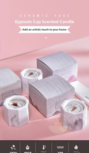 Macro view of marble textured scented candle with wooden wick and matching gift box