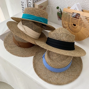 Handwoven straw hats with colorful ribbons for beach vacation and sun protection