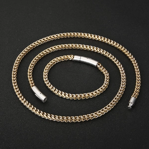Detail of two-tone titanium steel dragon bone chain with cylindrical clasp and mesh texture