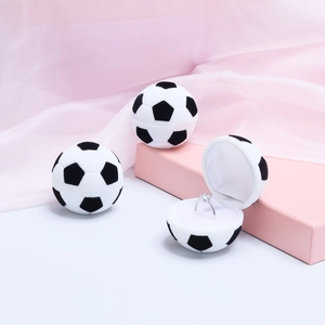 Macro view of velvet soccer ball jewelry box interior with single ring storage slot