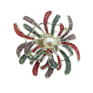 Elegant fireworks brooch with pearl and colorful rhinestones on a clean white background