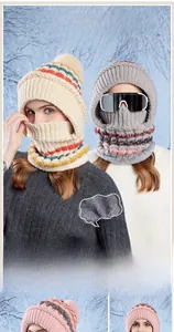 Detail of winter knitted hood with thick fleece lining and large faux fur pom-pom