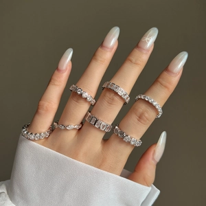 Detail of S925 sterling silver rings with geometric zirconia on a model's hand