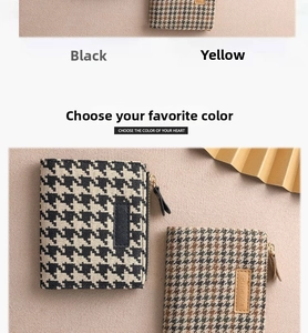 Detail of houndstooth zipper coin purse with leather logo patch in black and yellow