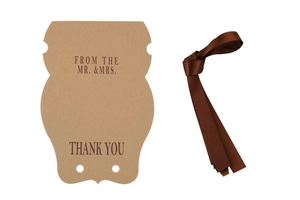 Detail of kraft paper pillow gift box with brown ribbon and Thank You printed text
