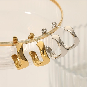 Irregular twisted geometric hoop earrings in gold and silver finish stainless steel