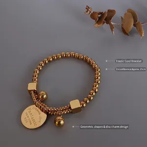 Bracelet élastique double couche plaqué or avec perles et pendentif rond gravé