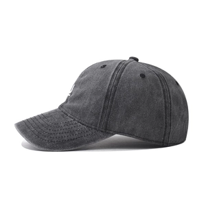Charcoal gray washed cotton baseball cap with white U-letter embroidery in a side view
