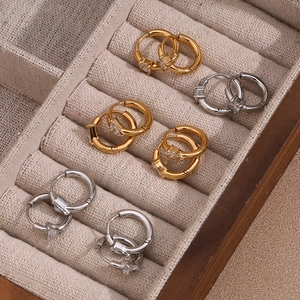 Macro view of gold and silver plated hoop earrings with drop zircon in a jewelry box