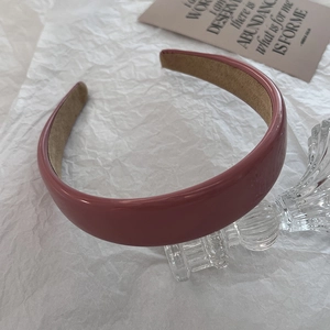 Close-up of pink PU leather wide headband with interior non-slip lining detail