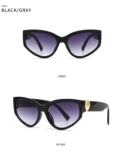 Detail of butterfly cat-eye sunglasses with golden heart hardware and purple gradient lenses