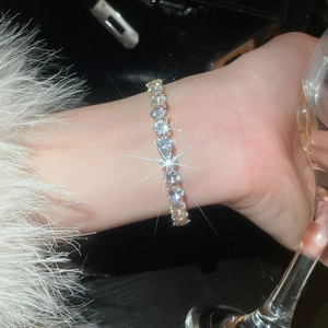 Sparkling gold tennis bracelet with brilliant-cut zircons worn on wrist for luxury style
