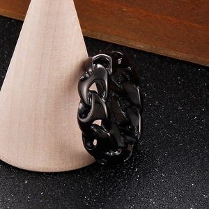 Polished black stainless steel Cuban link chain ring displayed on a wooden cone stand