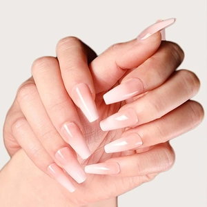 Close-up of pink ombre gradient long coffin press-on nails with a high gloss finish