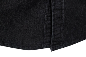 Macro shot of hem stitching on black denim shirt showcasing durable fabric texture