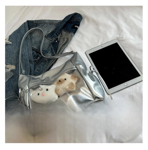 Detail of silver Y2K crossbody bag with clear window pocket and star plush charms