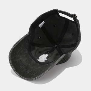 Washed black cotton baseball cap with 100% cotton label and adjustable metal buckle