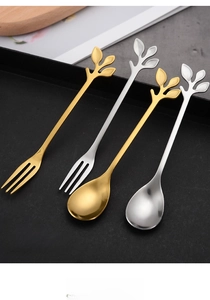 Detailed view of leaf-shaped handle on gold and silver stainless steel spoons and forks