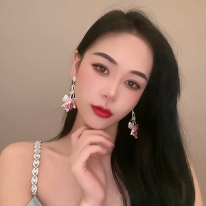 Detailed view of model wearing luxury tulip floral earrings with colorful zircons