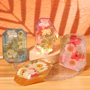 Detailed view of dried flower resin crystals on a warm lighted wooden base