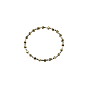 Detailed view of two-tone gold and silver beaded bracelet with polished metallic finish