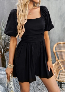 Detail of the textured fabric on the black square neck puff sleeve romper for women