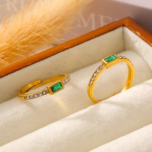 Adjustable 18k gold plated ring with emerald green glass stone and side crystal accents