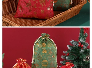Close-up of red and green cotton drawstring gift bags with gold foil Christmas patterns