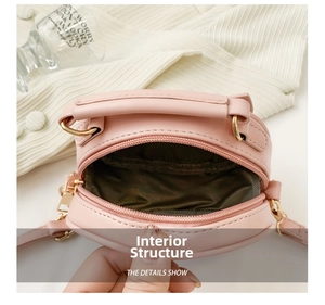Internal structure detail of soft pink mini bag with brown lining and gold hardware
