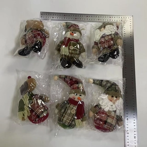 Detailed view of 6-piece Christmas plush ornaments in classic red and green plaid outfits