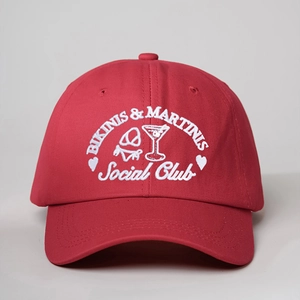 Red cotton baseball cap featuring white BIKINIS & MARTINIS Social Club embroidery
