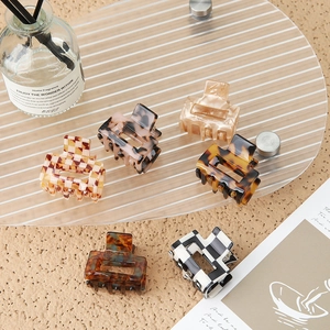 Premium acetate shark hair claws in amber, leopard, and checkerboard patterns for women