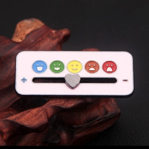 Macro detail of enamel slider pin featuring a heart marker and colorful mood icons