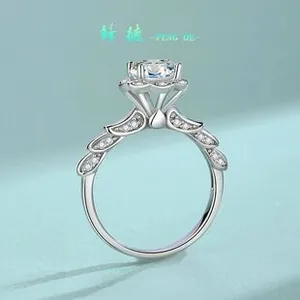Detail of S925 silver moissanite ring with six-prong setting and feather-like band