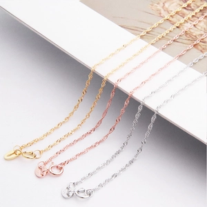 Macro shot of S925 sterling silver water wave necklaces in gold, silver and rose gold