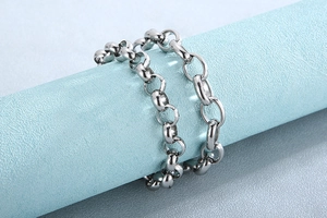 Close-up of a minimalist silver titanium steel bracelet on a blue cylinder display
