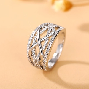 Close-up of infinity curve ring with shimmering cubic zirconia and hollow design