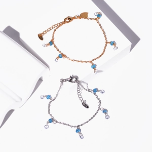 Close-up of gold and silver butterfly bracelets with blue and clear crystal beads