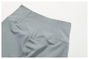 Detail of high waisted yoga shorts with V-shaped contour seams and smooth flatlock stitching
