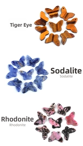 Macro detail of butterfly charms in tiger eye, sodalite, and rhodonite for DIY jewelry