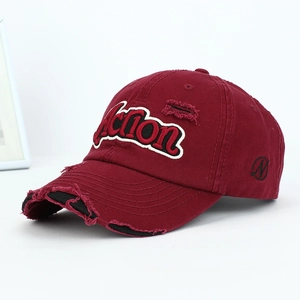 Detail of distressed burgundy baseball cap with white Action letter embroidery