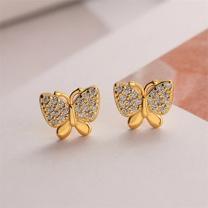 Detail of 18K gold plated bow earrings with sparkling rhinestones and vintage finish
