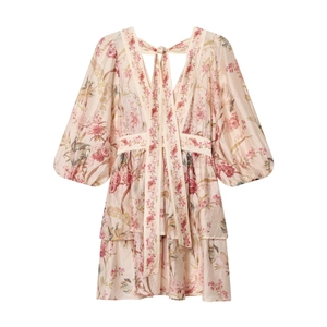 Detailed view of pink floral dress featuring puff sleeves and a deep V-neckline design
