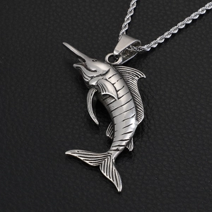 Detailed close-up of a silver tuna swordfish pendant on a twisted chain over black leather
