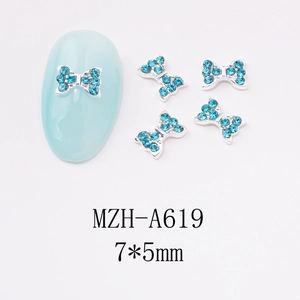 Macro view of blue rhinestone nail art bow MZH-A619 measuring 7x5mm on a light blue nail