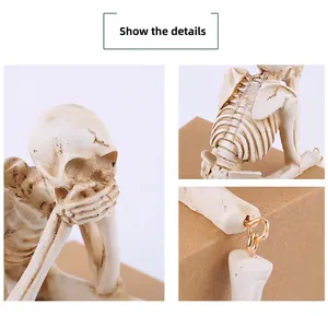 Close-up of resin skeleton joints with gold metal rings and aged texture detail